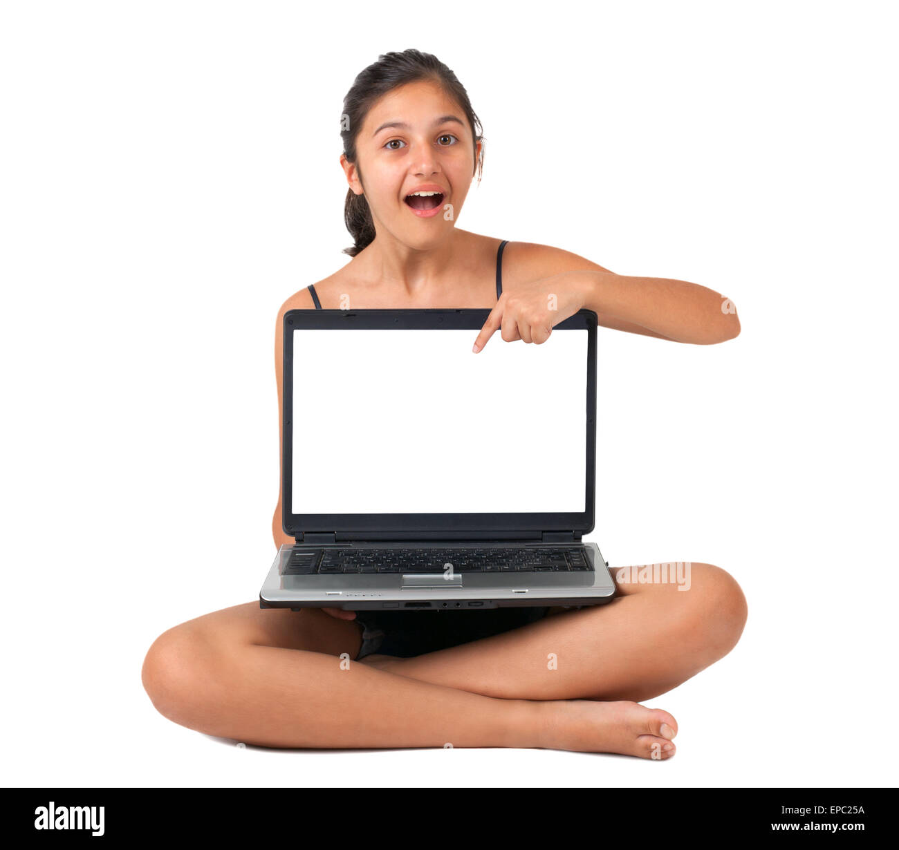 Adolescente puntando con il dito lo schermo vuoto del portatile. Foto Stock