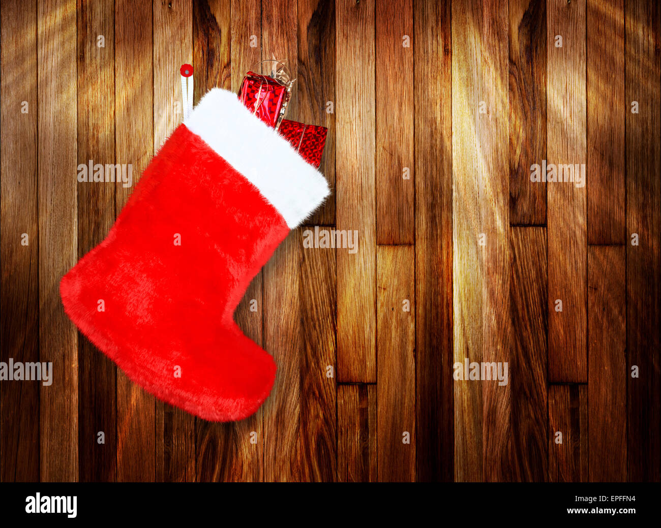 Rosso di avvio di natale con doni su sfondo parete in legno Foto Stock