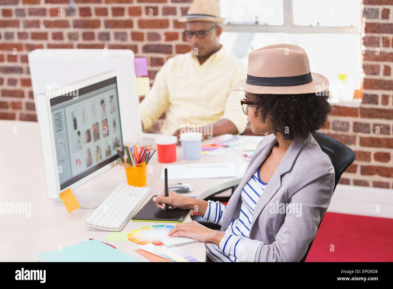 Femmina editor di foto utilizzando il digitalizzatore in office Foto Stock