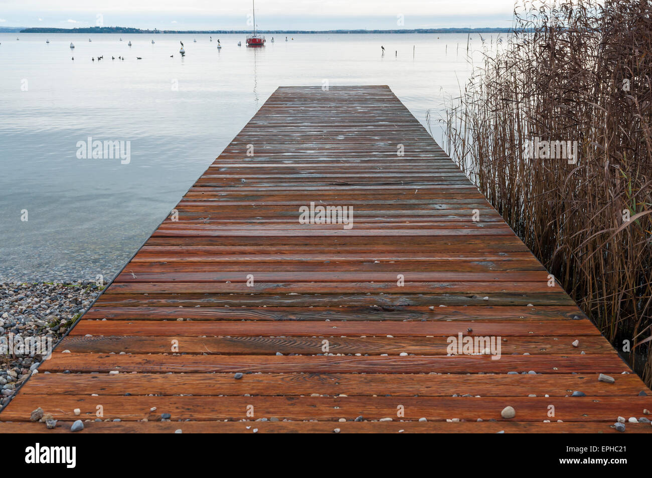 Il molo di legno inverno vista del lago di Garda, da Moniga del Garda, Brescia, Italia. Prese su dicembre 7, 2014. Foto Stock