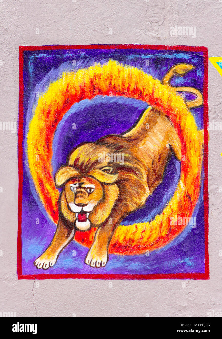 L'arte al Muro del circus lion saltare attraverso un cerchio di fuoco Foto Stock
