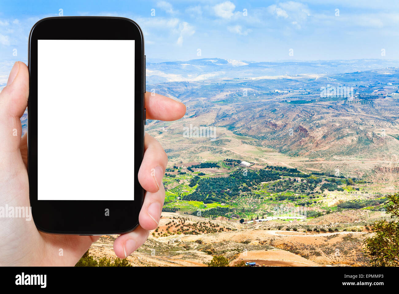 Concetto di viaggio - Fotografia turistica Terra promessa dal Monte Nebo in Giordania su smartphone con tagliare fuori schermo con vuoto posto f Foto Stock