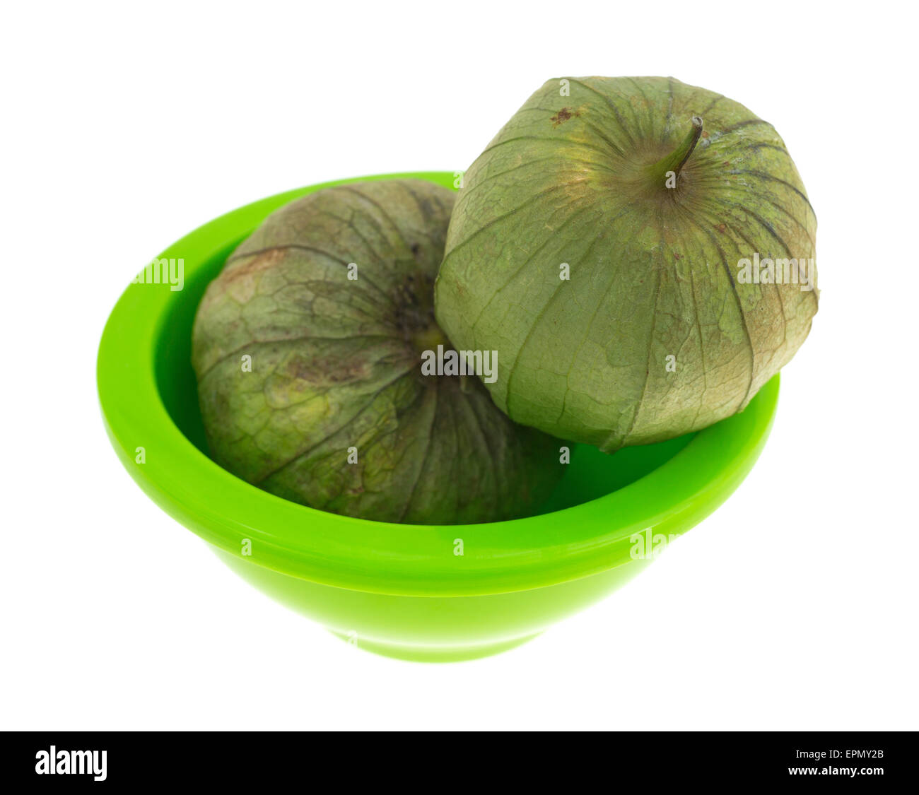 Un piccolo piatto verde con due mature tomatillos su uno sfondo bianco. Foto Stock