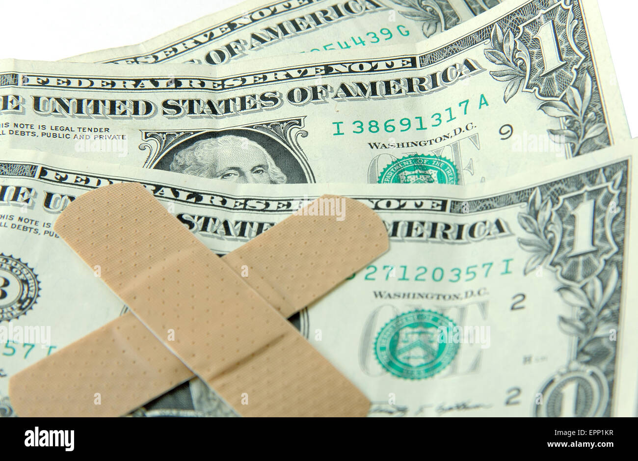 Le fatture del dollaro con band-aids = disagi economici Foto Stock