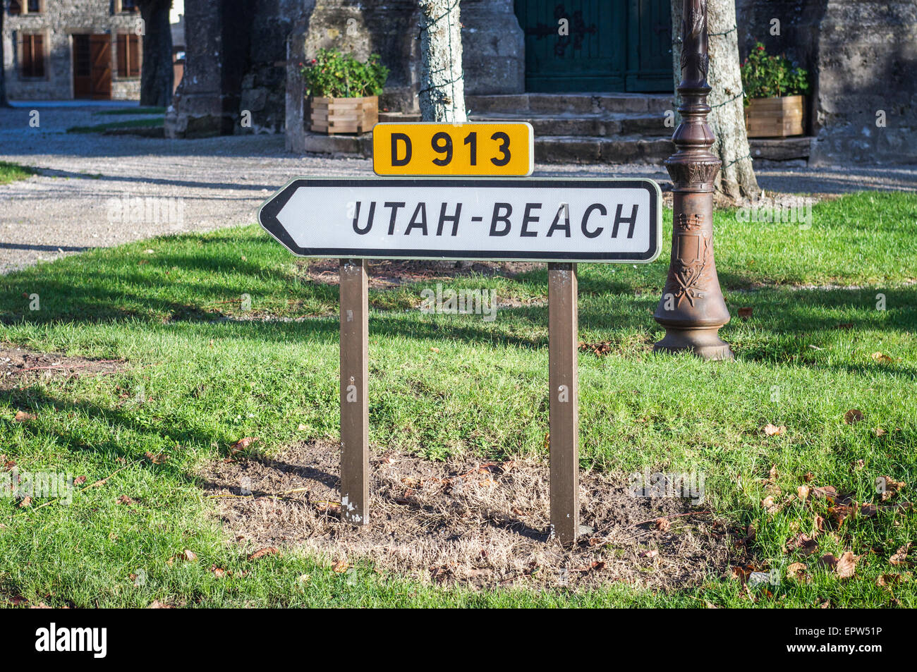 Segno per il D-913 strada in un villaggio francese in Normandia indicante la direzione dello Utah Beach, la II Guerra Mondiale lo sbarco sulla spiaggia. Foto Stock