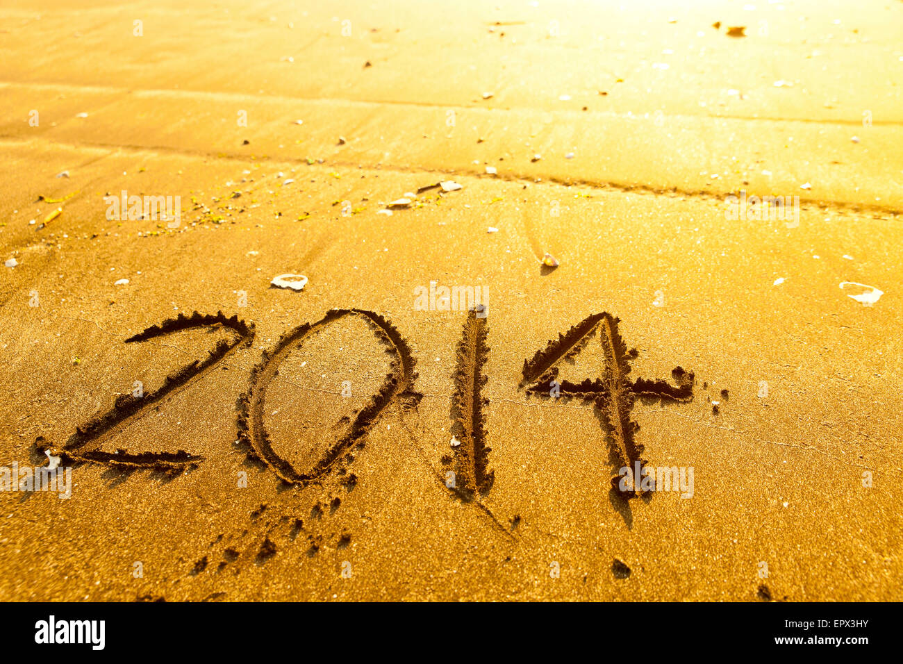 Anno Nuovo 2014 cifre sulla spiaggia dell'oceano sabbia Foto Stock