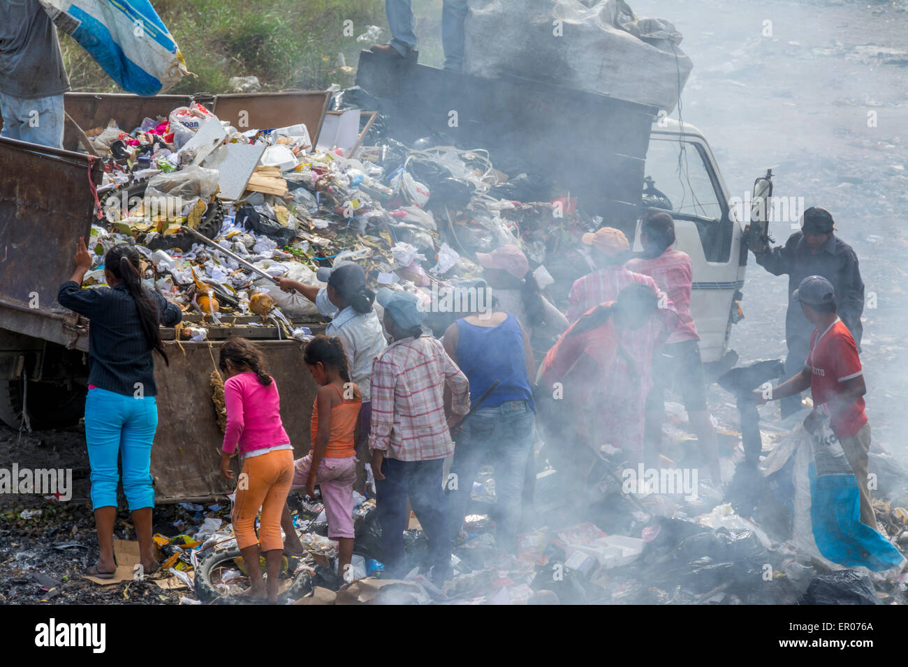 I poveri lo scarico e lo smistamento recyclables da un camion della spazzatura in Guatemala Foto Stock