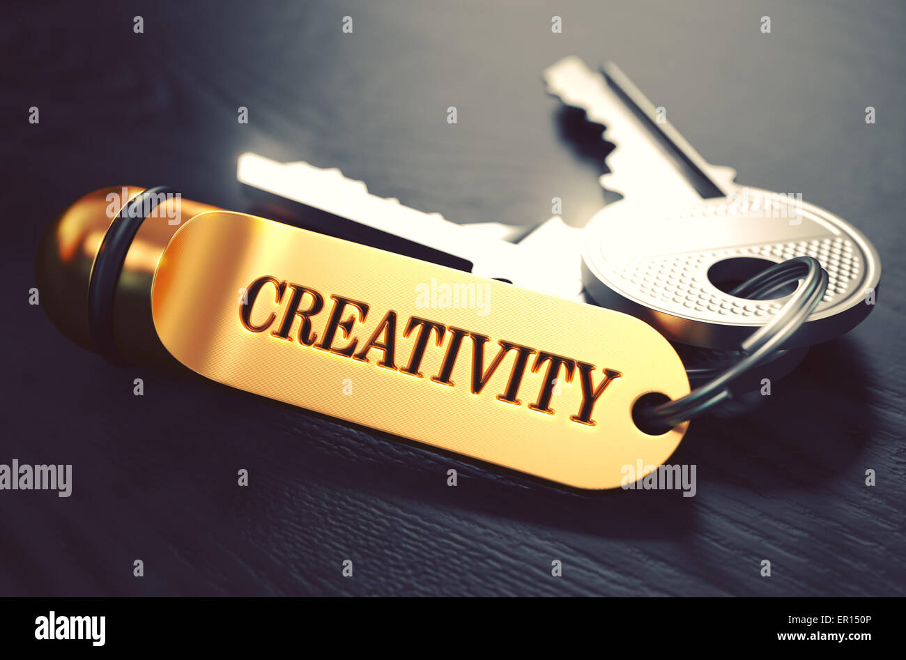 Le chiavi con la parola 'creatività' su Golden etichetta. Foto Stock