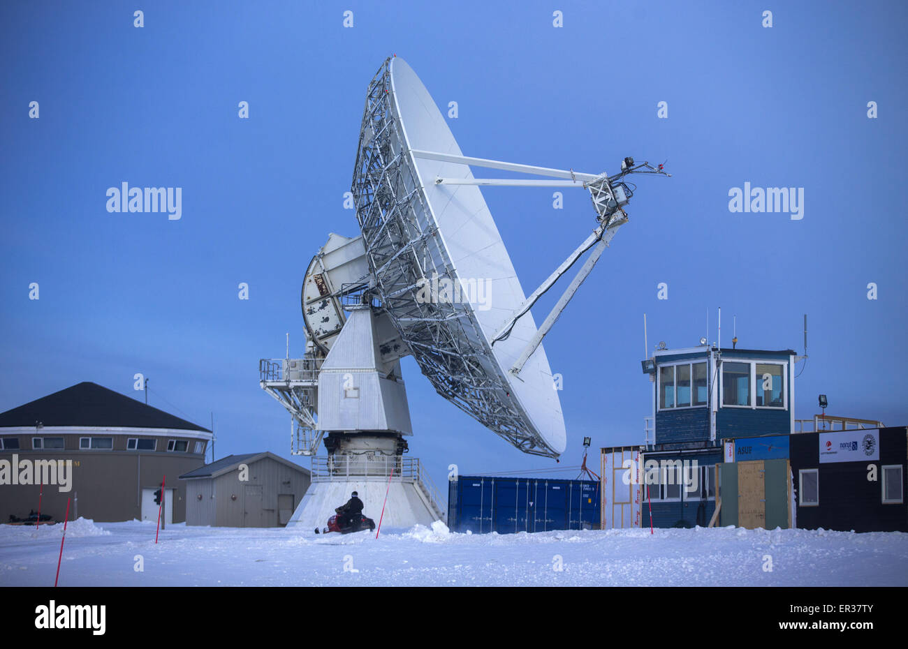 Una gigantesca antenna VLBI dalla mappatura norvegese competente (NMA) gira su Spitsbergen in Ny-Aelesund, Norvegia, 10 aprile 2015. L'installazione ha lavorato dal 1992 come parte di una rete globale di antenne VLBI, e misura la rotazione della terra la velocità, controlla il movimento continentale e aiuta con la previsione dei terremoti e maremoti. Dal 2003, in tedesco e in francese gli scienziati hanno lavorato al AWIPEV Artico Base ricerca nella ex minatori' insediamento nell'arcipelago delle Svalbard. Il lavoro scientifico condotto presso la stazione di Koldewey include il monitoraggio del nord stratosp polare Foto Stock