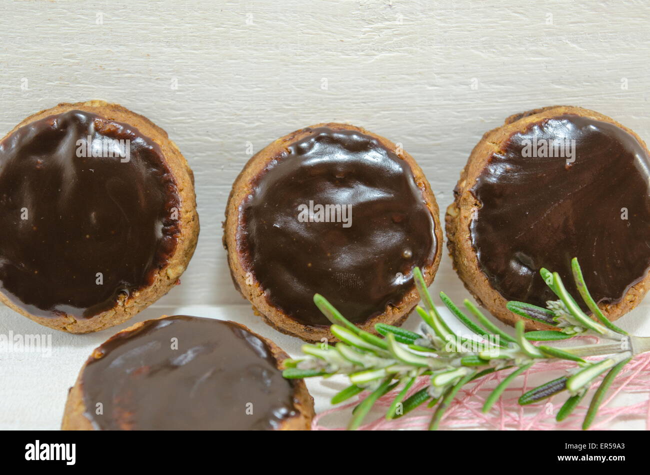 Biscotti con cioccolato fondente in piedi contro un pannello di legno Foto Stock