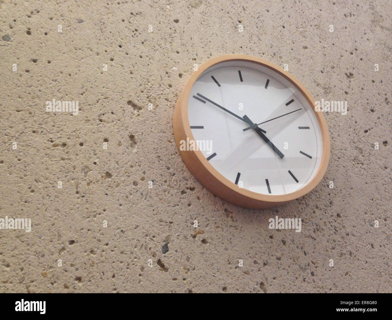 Semplice classica parete analogico orologio sul muro di pietra Foto Stock