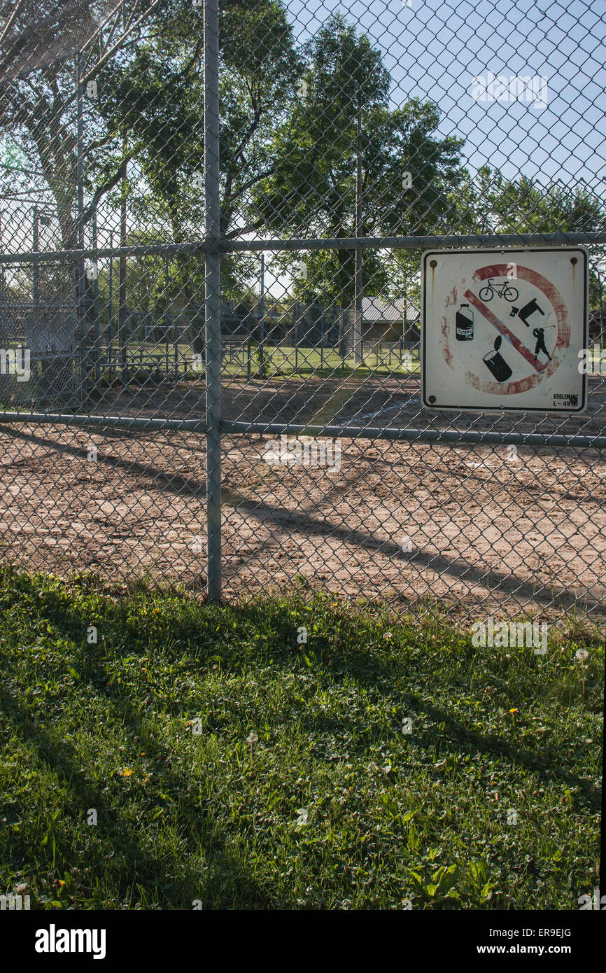 Arrugginita danneggiato il vecchio segno su una restrizione di recinzione no animali domestici, senza pelle, nessun cibo in un parco. Ruoli da seguire per mantenere un parco pulito. Foto Stock