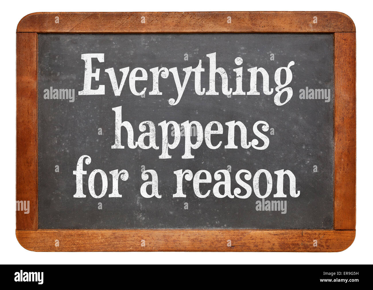 Tutto ciò accade per una ragione - il testo su un vintage lavagna ardesia Foto Stock