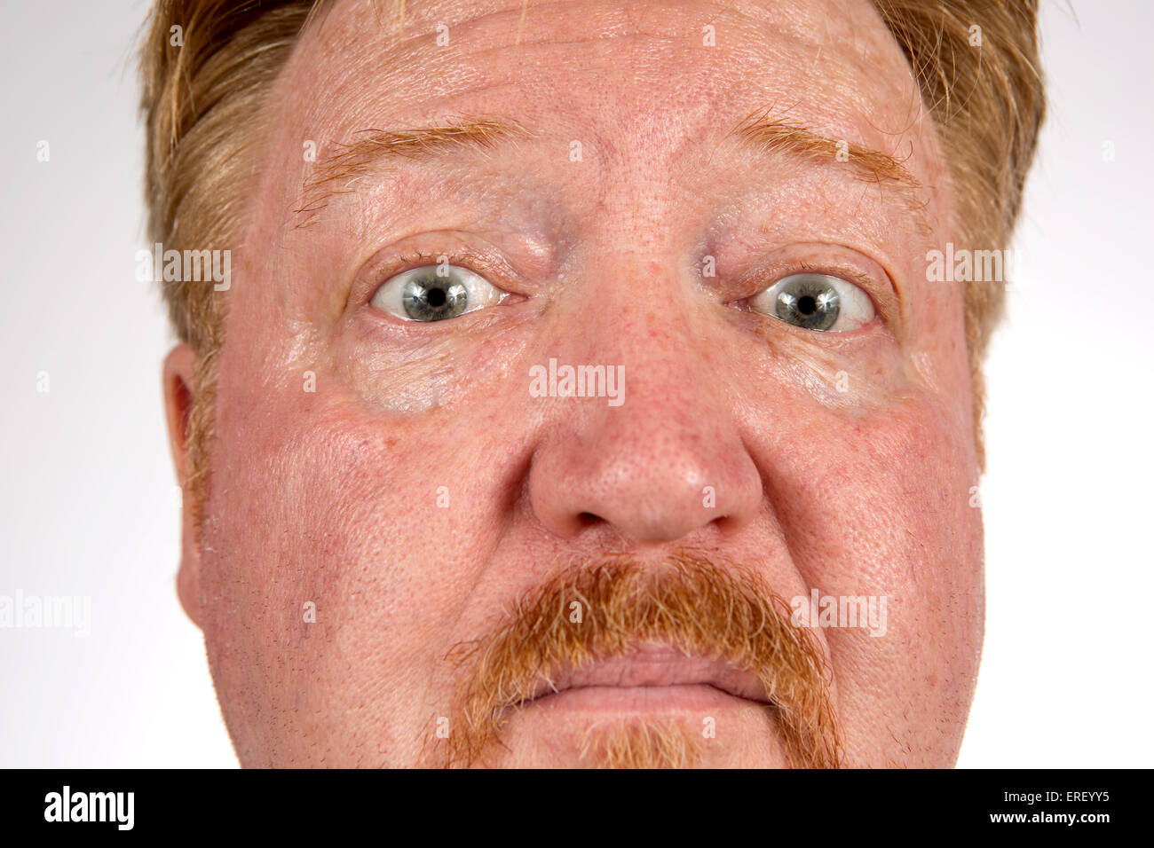 Close up dai capelli rossi uomo con un sospetto o espressione scettica sul suo volto. Foto Stock
