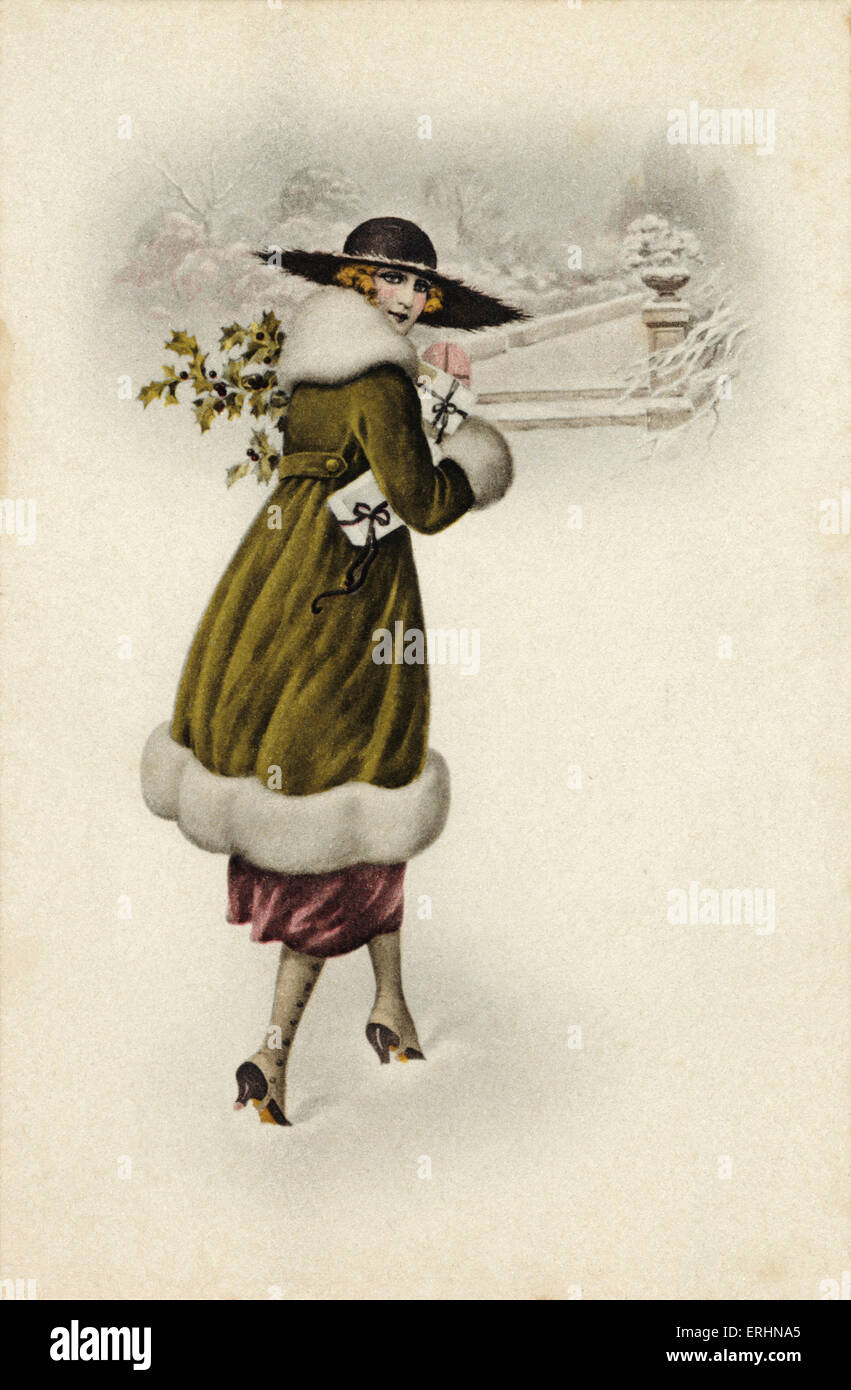 Natale scena di neve. Moda giovane donna che trasportano presente avvolto con nastri. Ampia colmato hat. Foto Stock