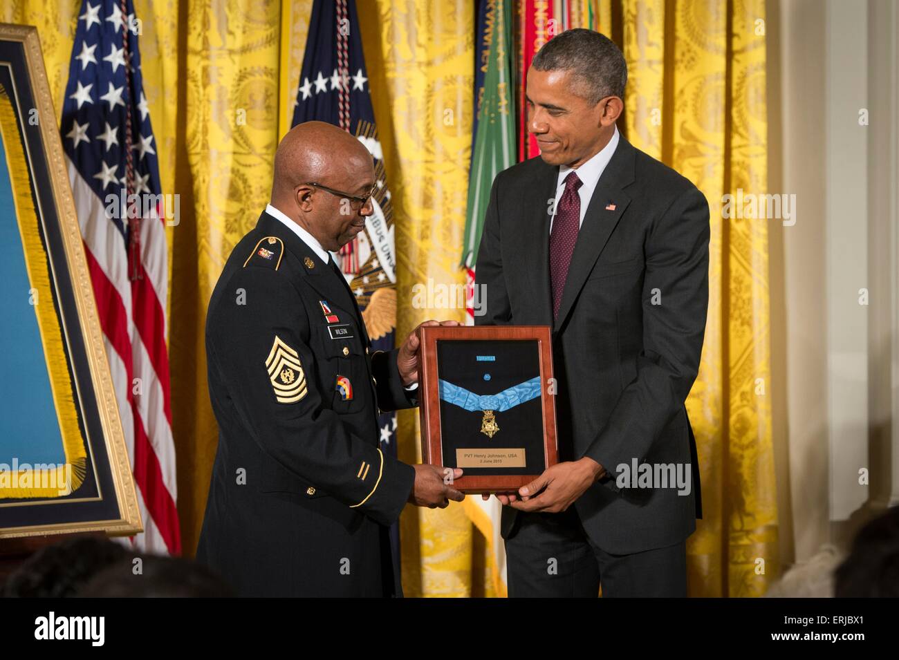 Stati Uniti Il presidente Barack Obama awards medaglia d'onore al comando Sergente Maggiore Louis Wilson della New York National Guard, che accetta a nome del tardo esercito Henry privato Johnson, per azioni mentre si serve in Francia durante la Prima Guerra Mondiale, nel corso di una cerimonia che si terrà nella Sala Est della Casa Bianca il 2 giugno 2015 a Washington, DC. Obama ha ricevuto la medaglia di due eroi di guerra i cui atti sono andati unrewarded nel corso della loro vita, a causa della discriminazione. Foto Stock