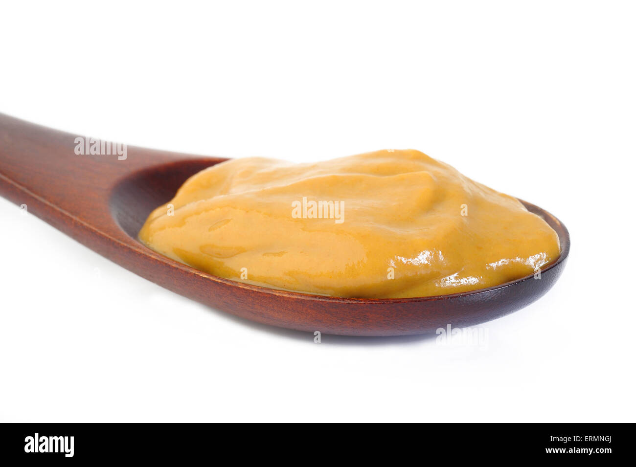 La salsa di senape in cucchiaio di legno Foto Stock