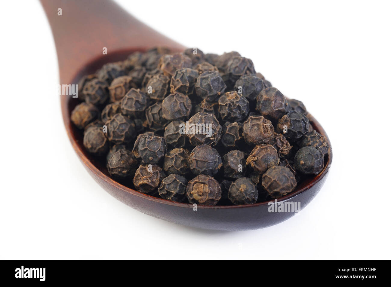 Pepe nero semi in cucchiaio di legno Foto Stock