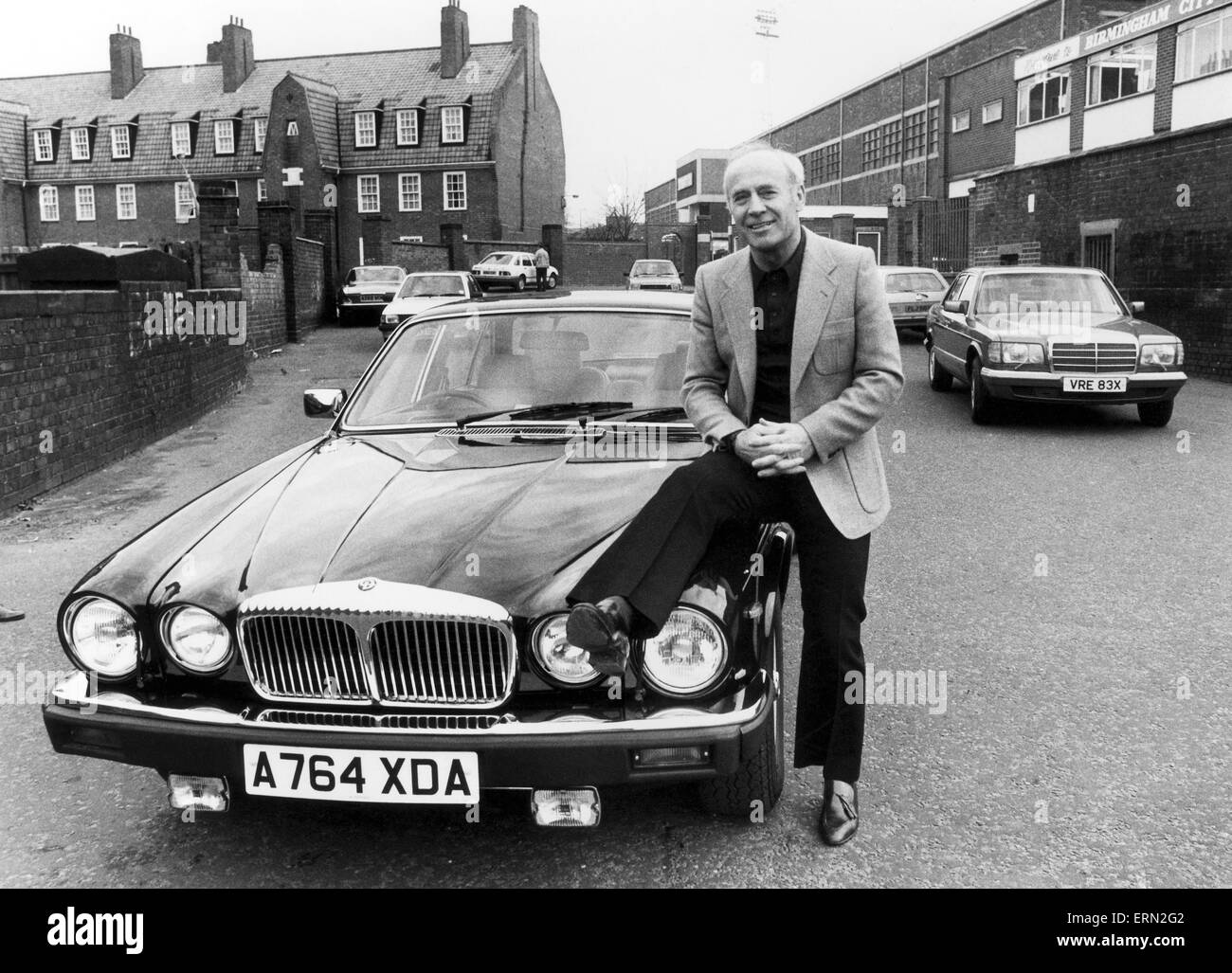 Birmingham City Football Manager Ron Saunders pone accanto alla sua Daimler al di fuori del club home terra St Andrews. Il 10 febbraio 1984. Foto Stock