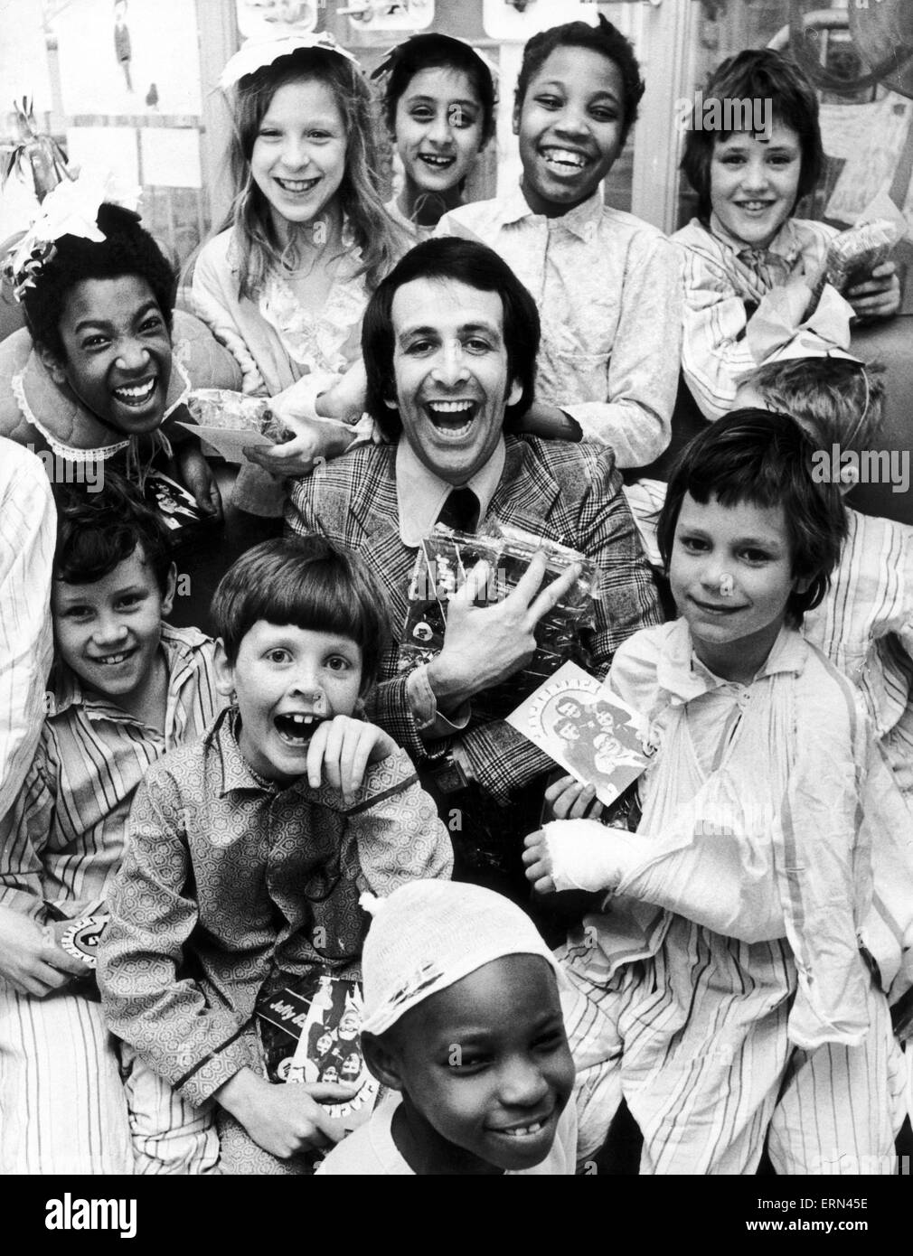 Don Maclean, attore e comico, rende la valutazione aspetto e mani doni per i bambini ricoverati in ospedale Ward, 5 aprile 1974. Foto Stock
