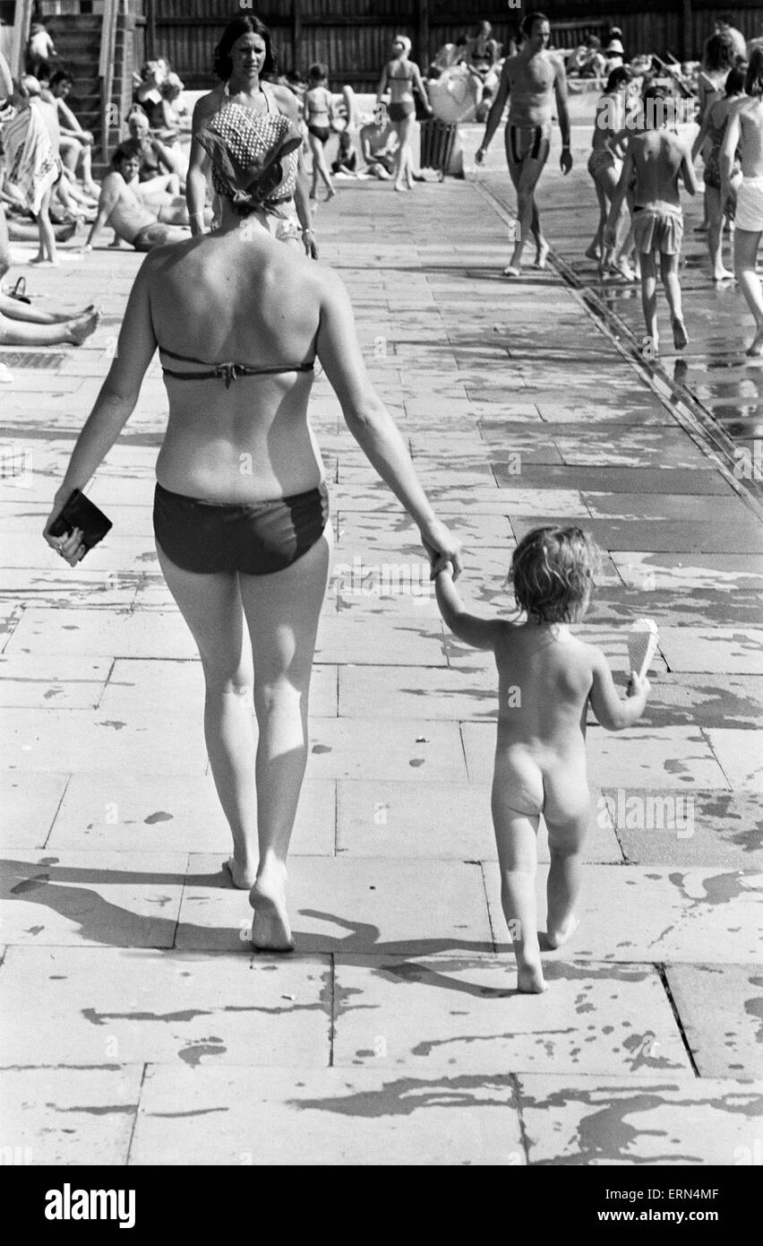 La madre e il bambino tenta di conservare al fresco a Birmingham lido durante la canicola estiva del 1976. Il 28 giugno 1976. Foto Stock