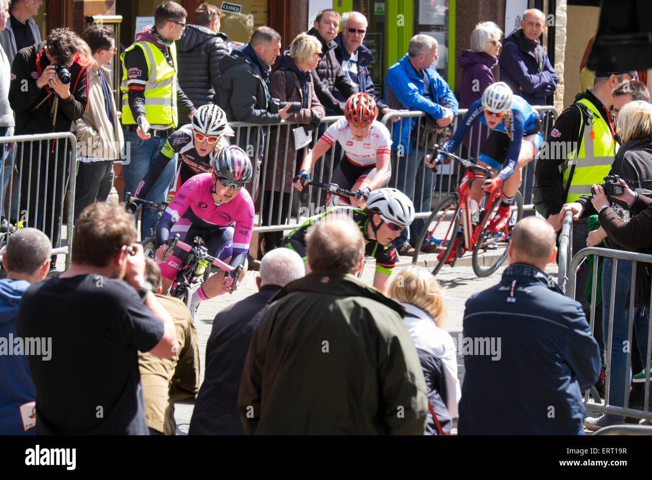 Piloti in gara ladies accendere per High Street durante il 2015 Shrewsbury Grand Prix, Shropshire, Inghilterra. Foto Stock