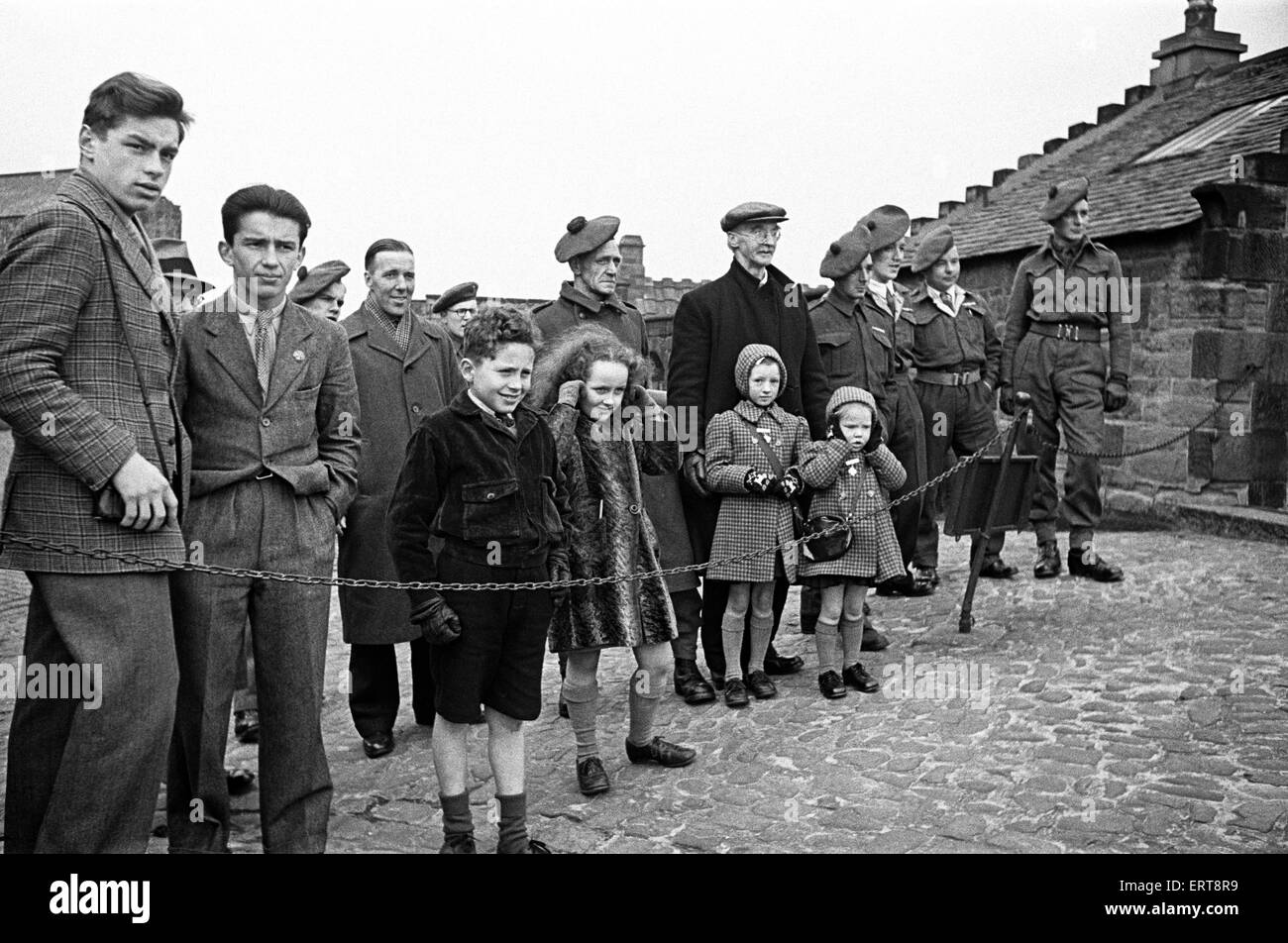 I turisti in visita a ore una pistola o pistola di tempo, al Castello di Edimburgo. Si tratta di un segnale di tempo, cotto ogni giorno alle 13:00, a prescindere da domenica, il Venerdì Santo e il giorno di Natale, circa 1945. Foto Stock