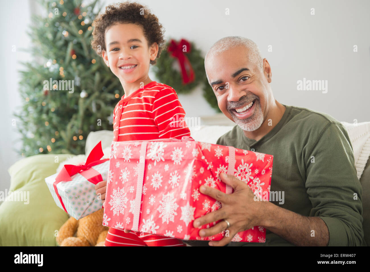 Razza mista nonno e nipote di aprire i regali di Natale Foto Stock