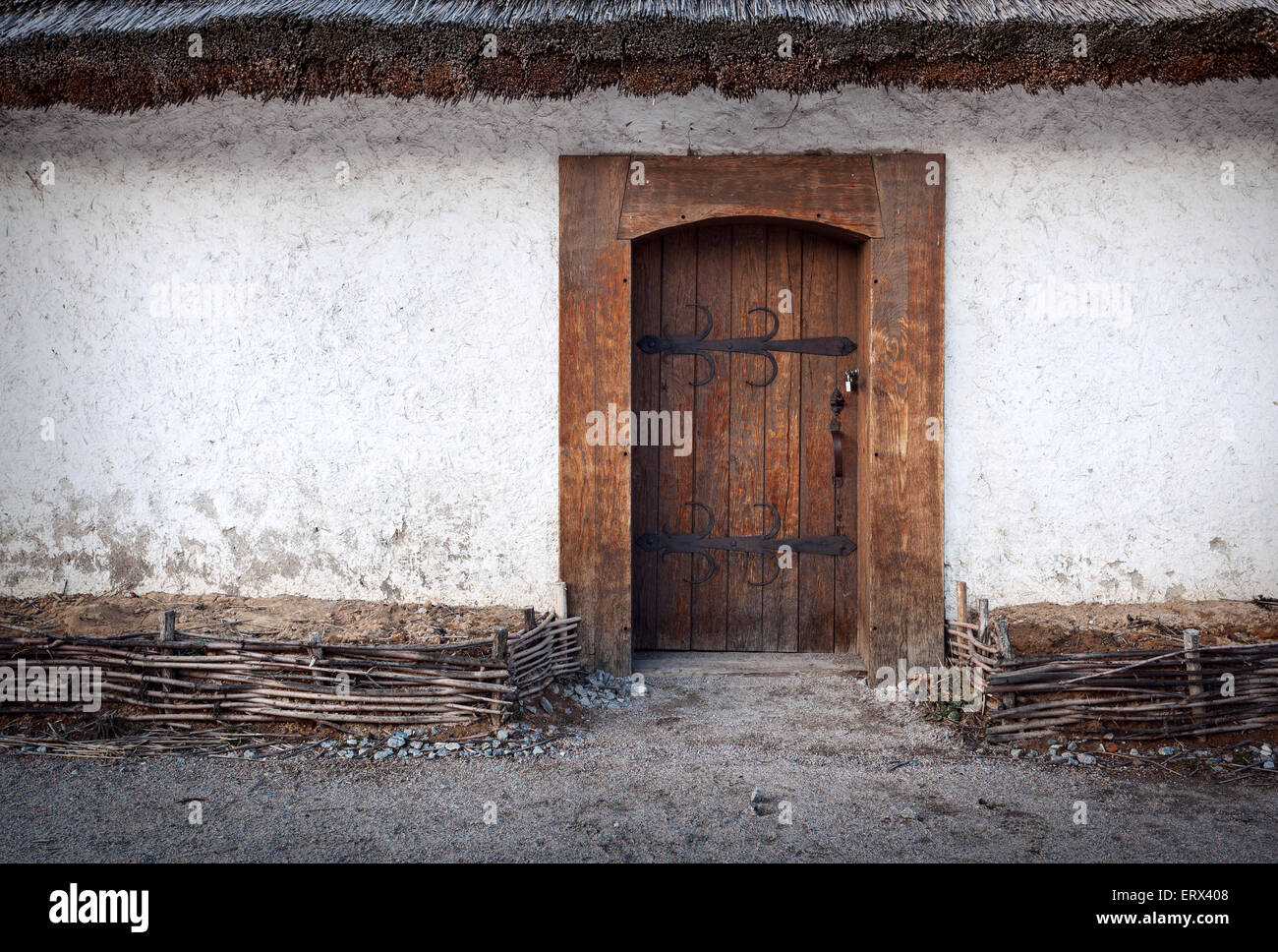 Vecchio legno porta con serratura e parete di argilla. Sfondo per la progettazione Foto Stock