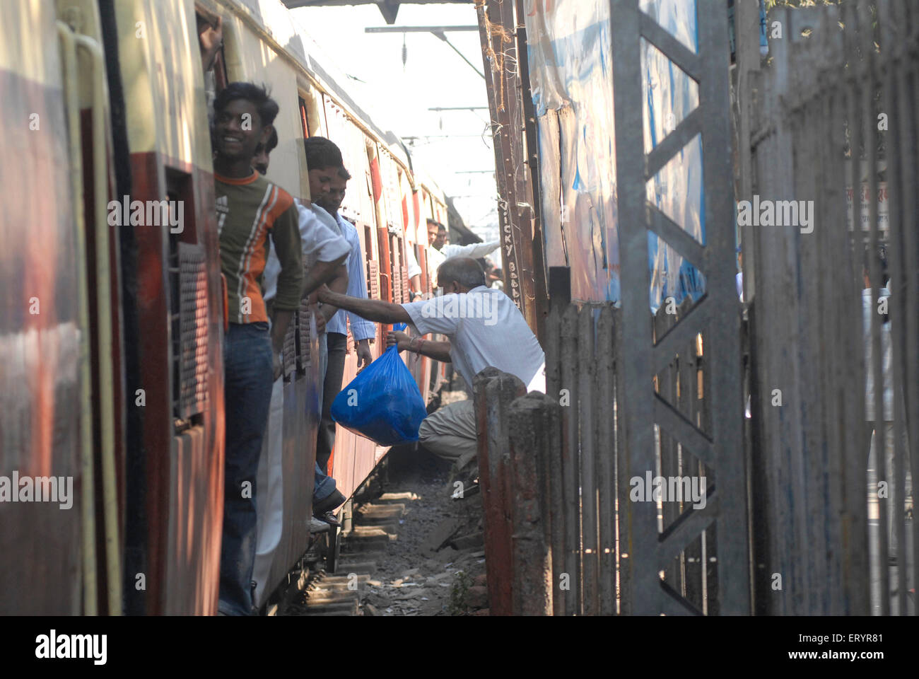 Persone che si immettono in treno autobus ferroviario pericolosamente , Bombay , Mumbai , Maharashtra , India , Asia Foto Stock