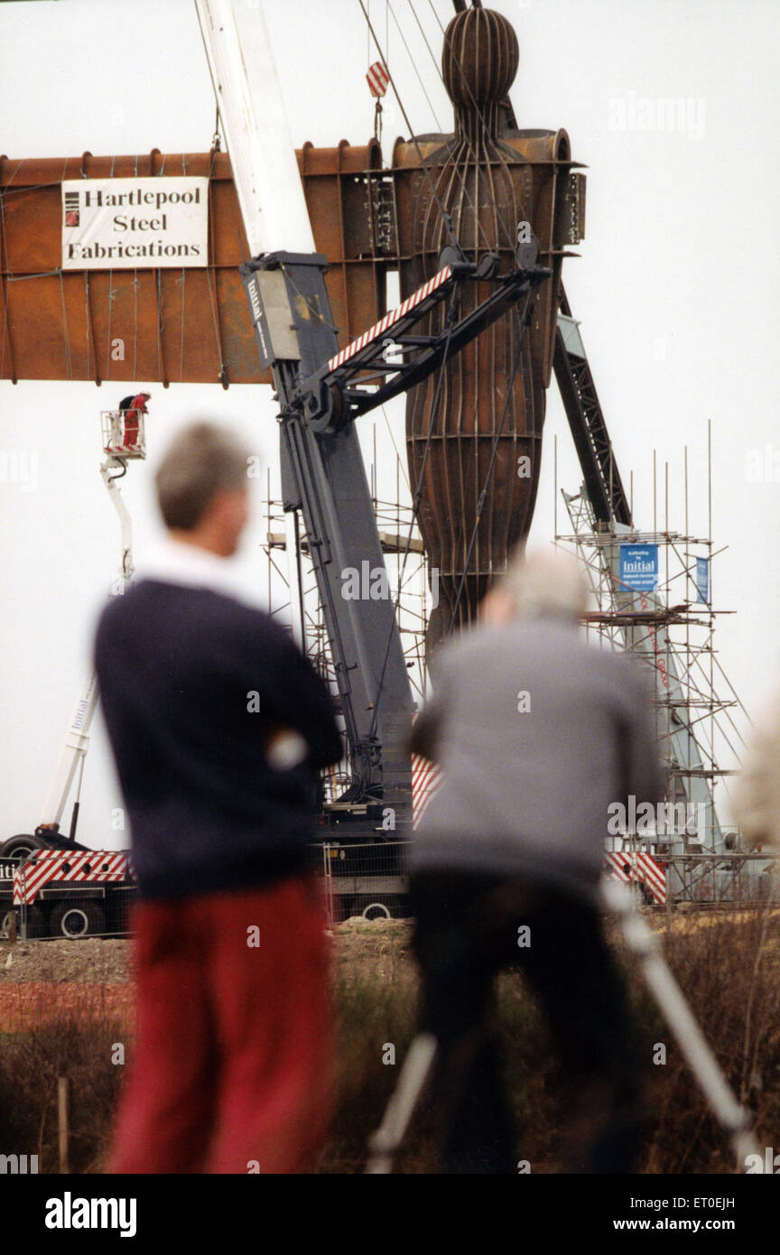 L Angelo del Nord è una scultura contemporanea, progettato da Antony Gormley, che si trova a Gateshead, Tyne and Wear, Inghilterra. Si tratta di una scultura in acciaio di un angelo, 20 metri (66 piedi) di altezza, con ali la misura 54 metri (177 ft). Le ali non stare dritto lateralmente, ma sono angolati 3,5 gradi in avanti; Gormley ha fatto questo per creare "un senso di abbracciare'. Si erge su una collina sul bordo meridionale della Bassa cadde, affacciato sulla A1 e A167 strade in Tyneside e la East Coast Main Line itinerario ferroviario, a sud del sito del Team Colliery. (Foto) lavoratori edili a Gateshead un Foto Stock