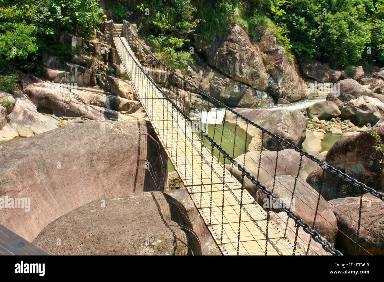 Ponte di sospensione in una valle sopra il fiume. Foto Stock