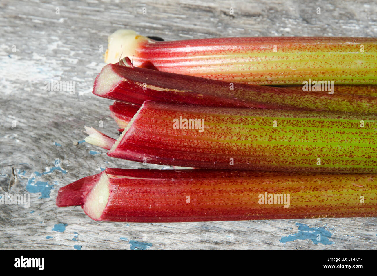 Close up di un mazzetto colorato stocchi di rabarbaro in un tavolo di legno Foto Stock