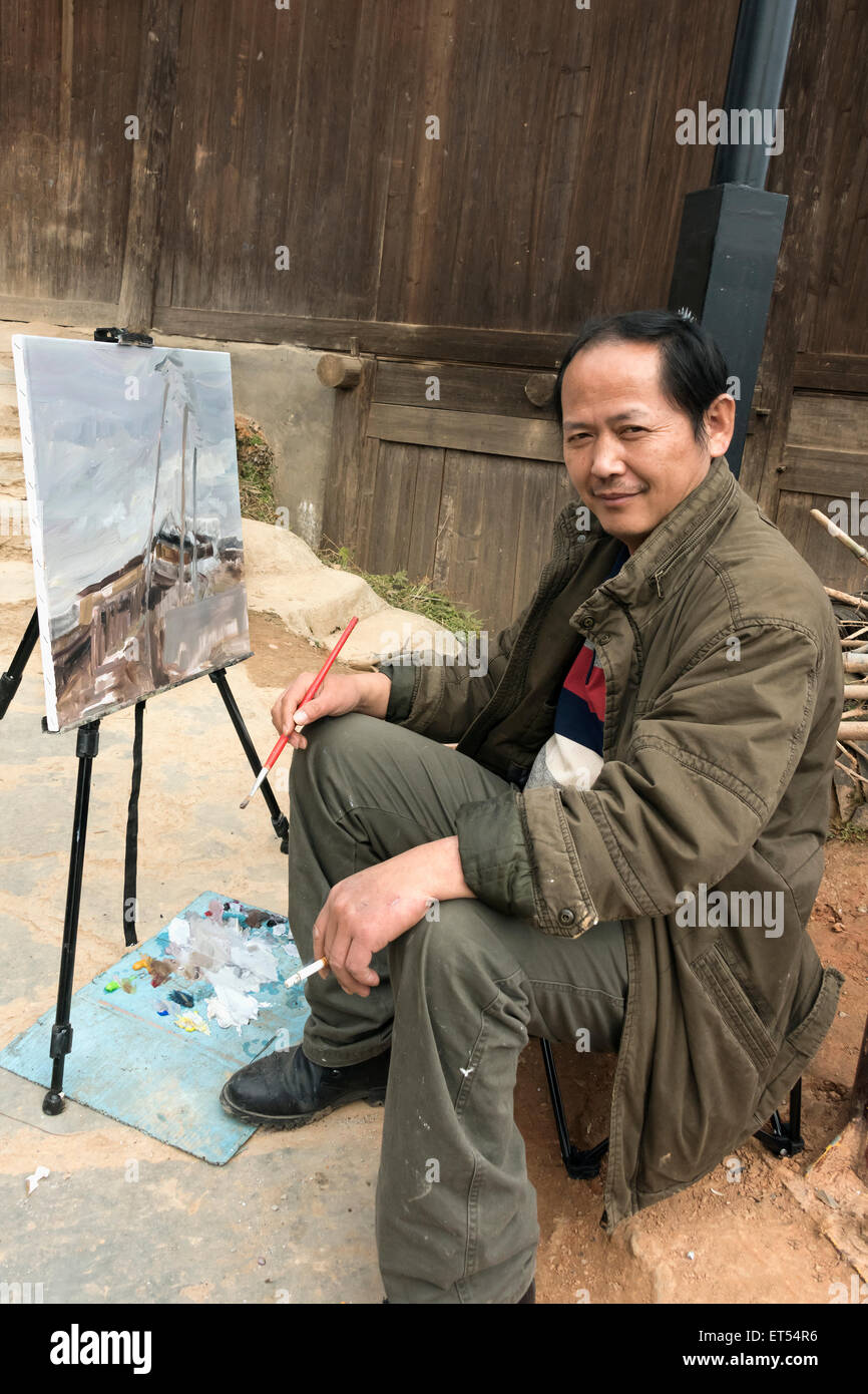 Artista facendo un dipinto nella pistola Basha Village, Guizhou, Cina Foto Stock Artista facendo un dipinto nella pistola Basha Village, Guizhou, Cina Foto Stock