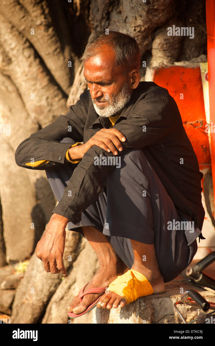 Uomo indiano con piede bendato seduta, Jaipur, Rajasthan, India Foto Stock