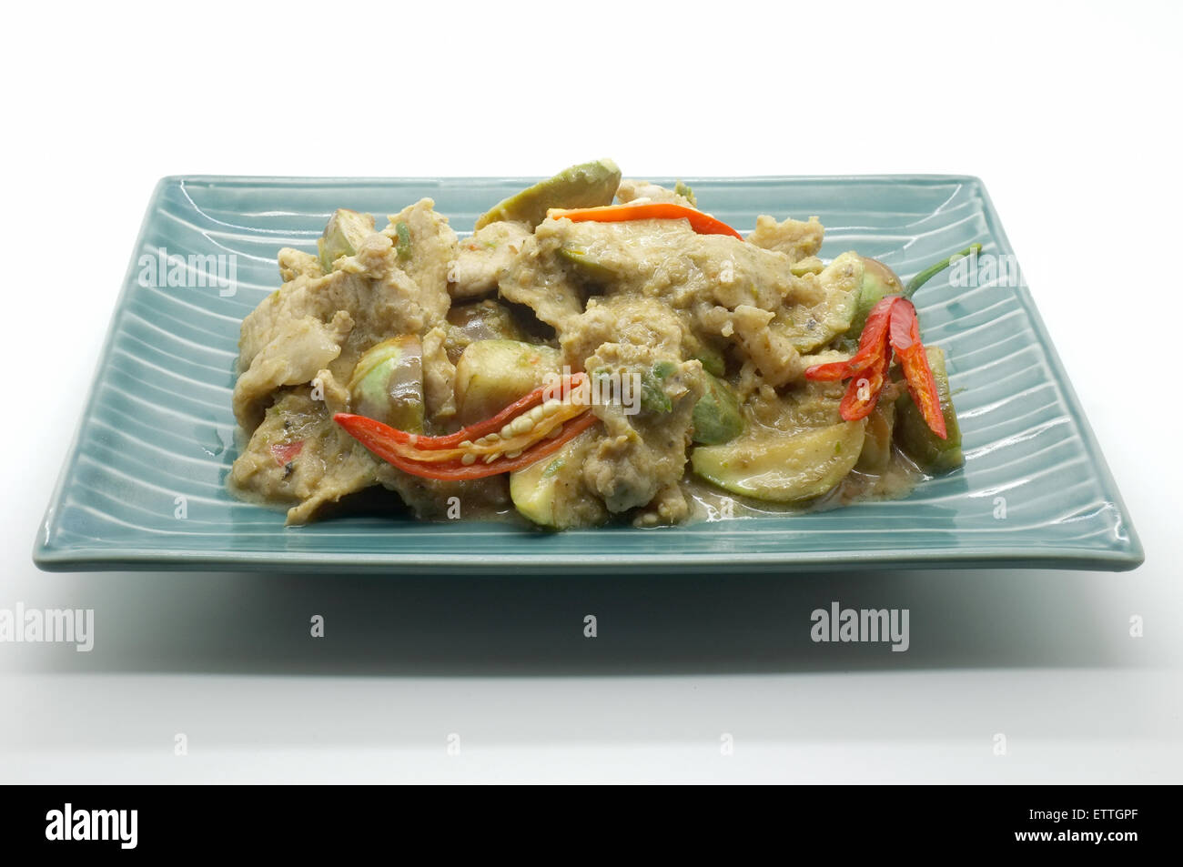 Fried curry verde con carne di maiale e melanzana, cibo tailandese Foto Stock