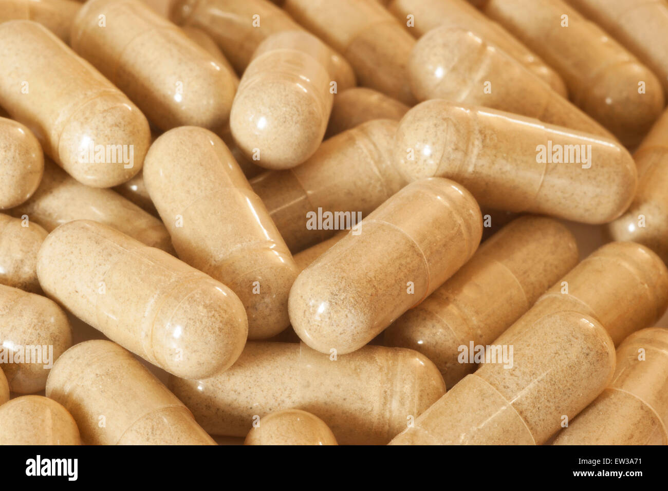 Farmaco Generico capsule contenenti polvere bruno chiaro formando uno sfondo. Foto Stock