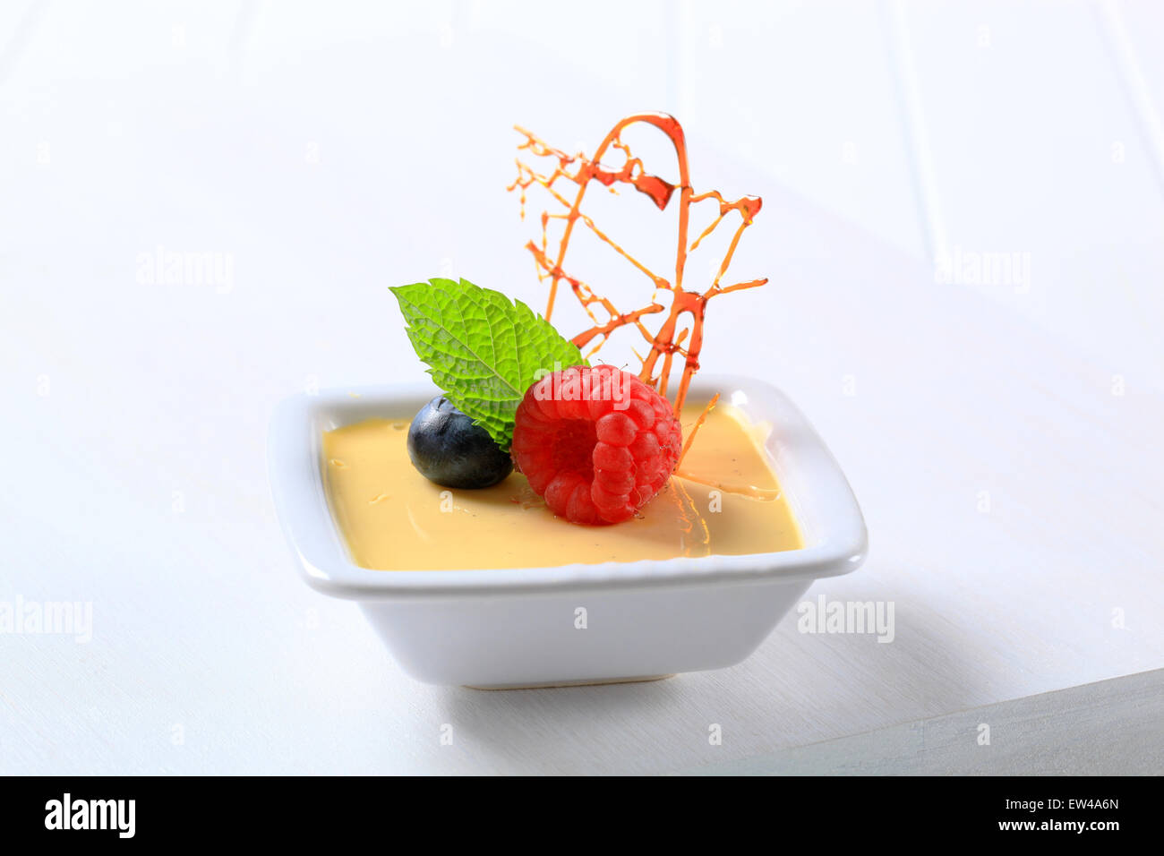 Piccolo piatto di crema alla vaniglia guarnita con frutta Foto Stock