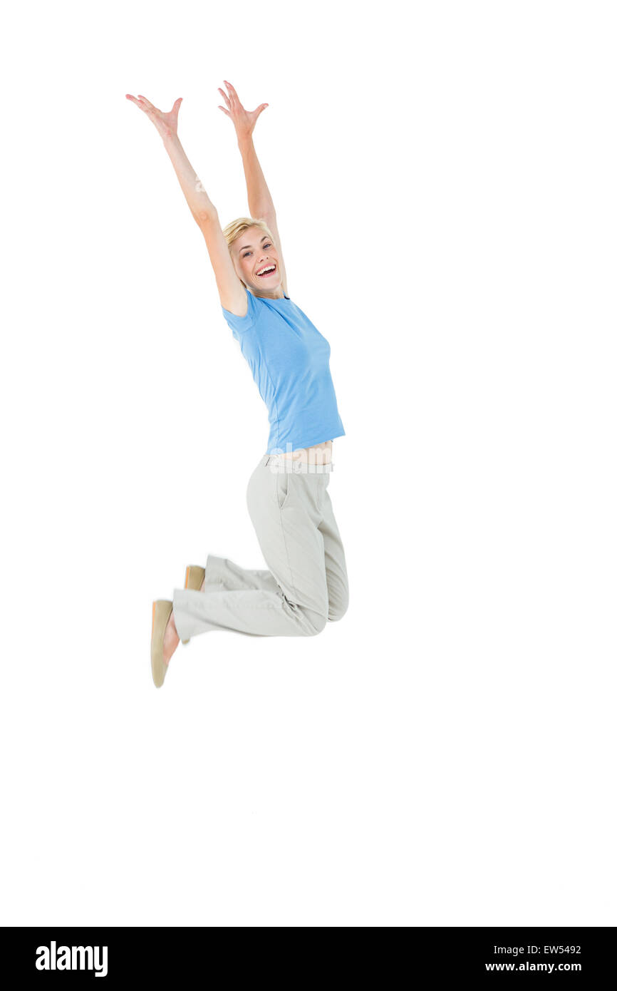 Allegra donna bionda jumping Foto Stock