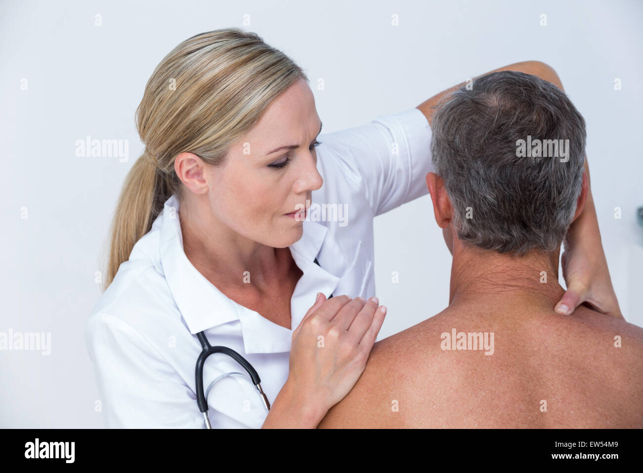 Medico di esaminare la sua spalla del paziente Foto Stock