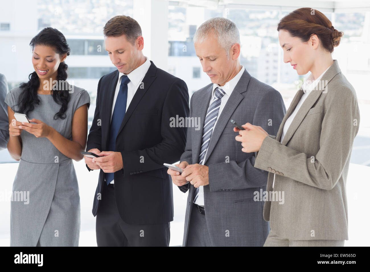 I dipendenti che utilizzano il loro telefono mobile Foto Stock