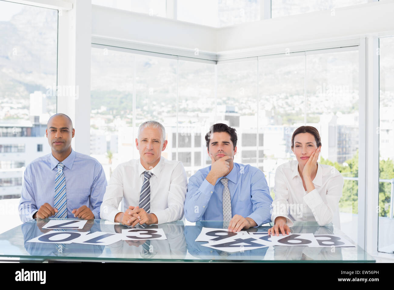 Concentrato team business seduto con il loro voto sulla scrivania Foto Stock