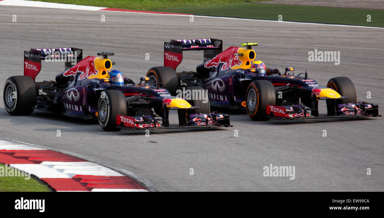 Sebastian Vettel supera il suo compagno di squadra Mark Webber durante il Gran Premio della Malesia 2013, dimostrando la sua abilità e determinazione in pista. La manovra, parte dell'intensa gara, è stata un momento chiave nella stagione di Formula 1 2013, riflettendo la feroce competizione e le dinamiche di squadra che hanno definito gli eventi di gara dell'anno. Foto Stock