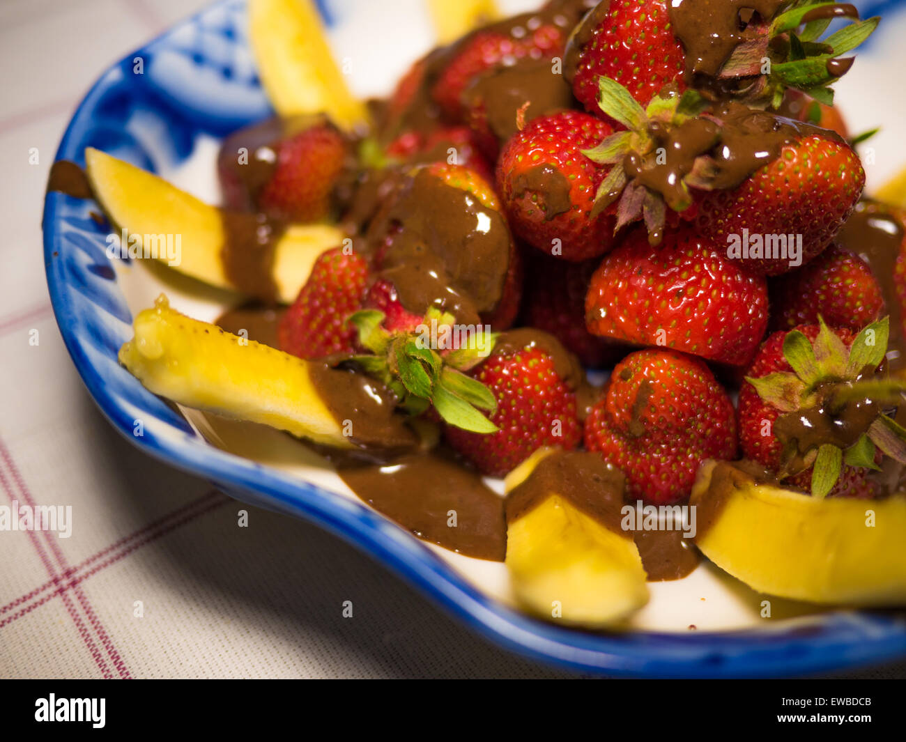 Banana e fragola sotto hot chodolate sulla tradizionale russo piastra - gzhel Foto Stock