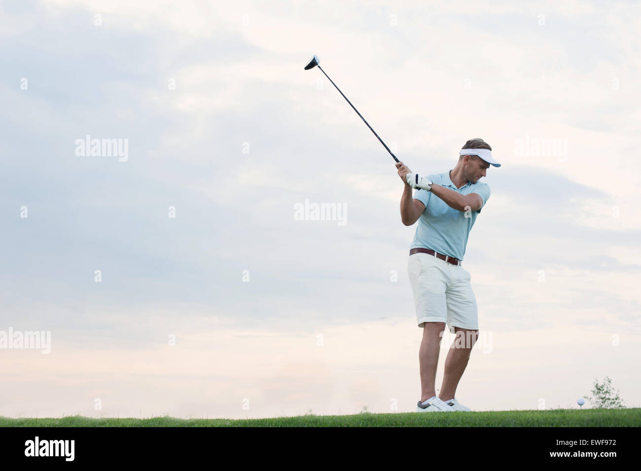 Metà di uomo adulto giocando a golf contro sky Foto Stock