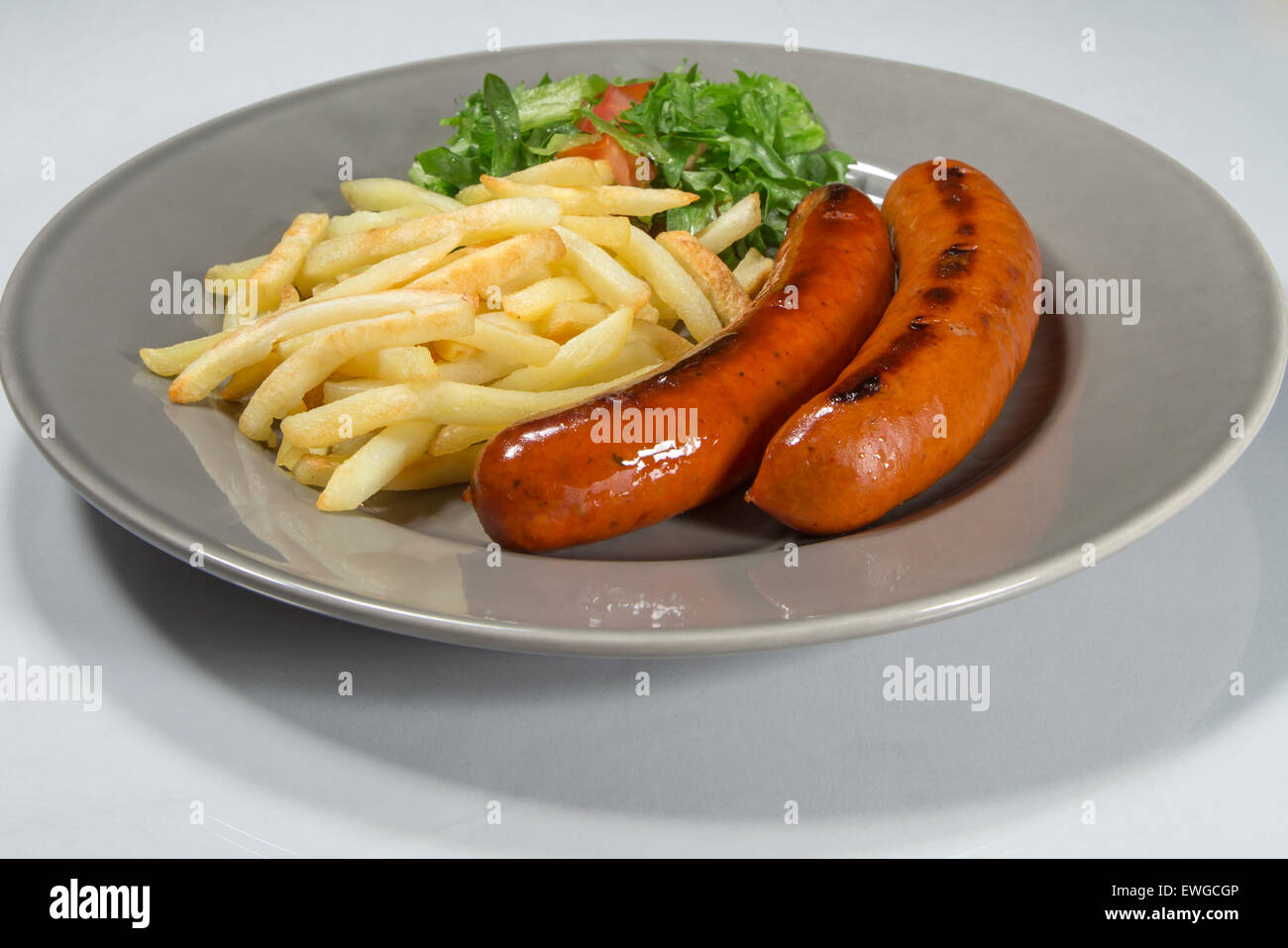 Salsicce e patate fritte Foto Stock