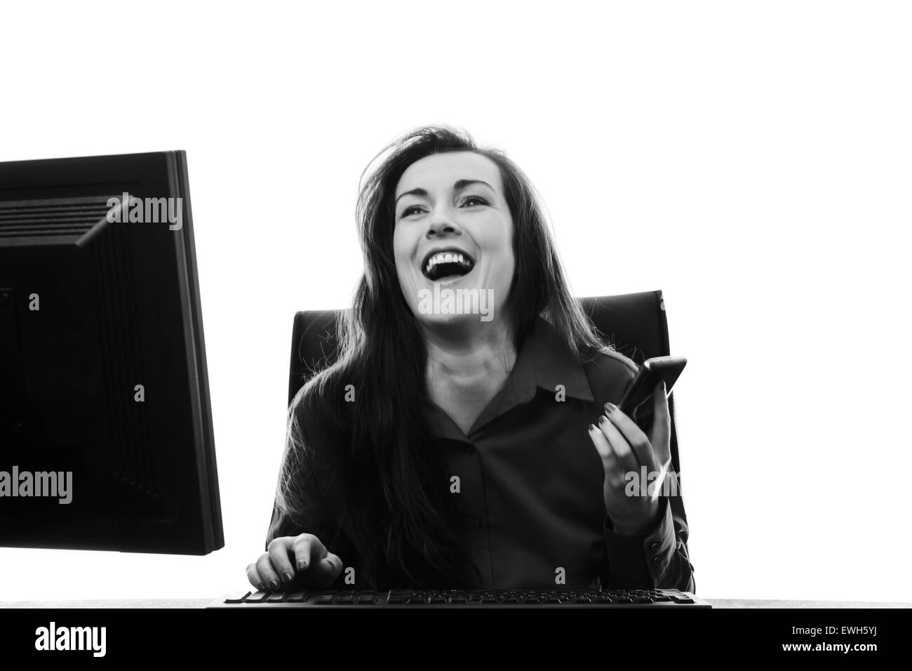 Felice di ridere imprenditrice lavorando alla sua scrivania Foto Stock