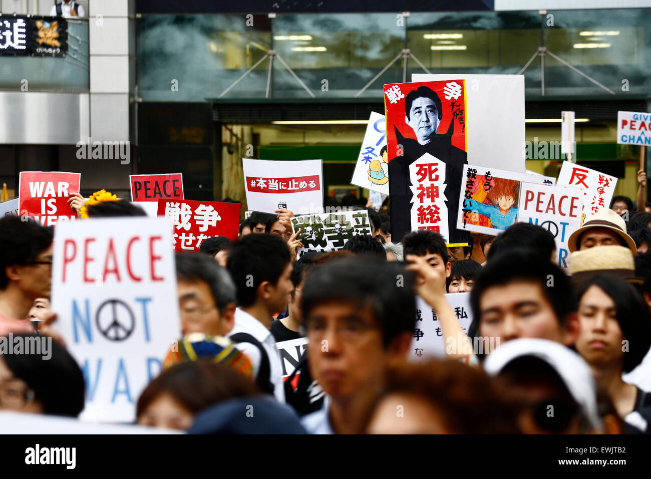 I membri di studenti azione di emergenza per la democrazia liberale-s (SEALDs) chiamata per la protezione del pacifista di articolo 9 della Costituzione giapponese in Shibuya quartiere dello shopping a giugno 27, 2015, Tokyo, Giappone. Circa mille persone hanno manifestato davanti alla famosa intersezione al di fuori della stazione di Shibuya contro il Primo Ministro Abe reinterpretazione dell articolo 9 che consentirebbe la nazione, le truppe per la lotta all'estero. © Rodrigo Reyes Marin/AFLO/Alamy Live News Foto Stock