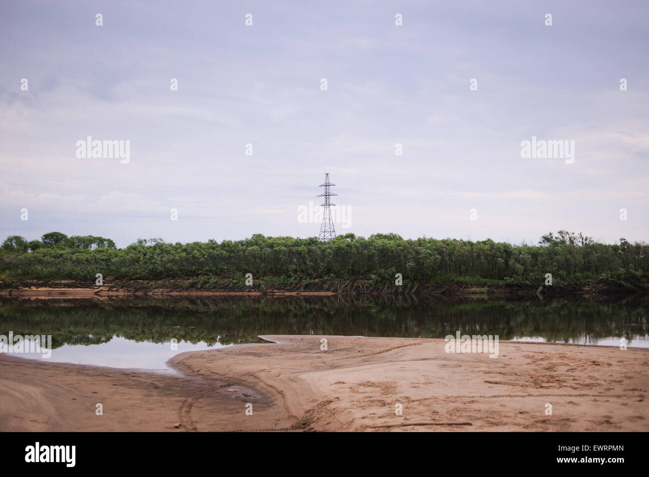 Banca di fiume vith linea elettrica su orizzonte Foto Stock