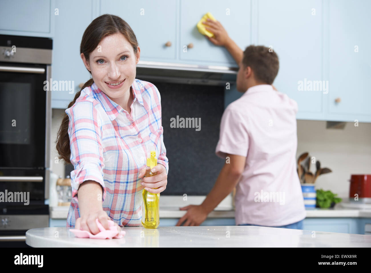 Paio di pulizia di superfici di cucina e armadi insieme Foto Stock